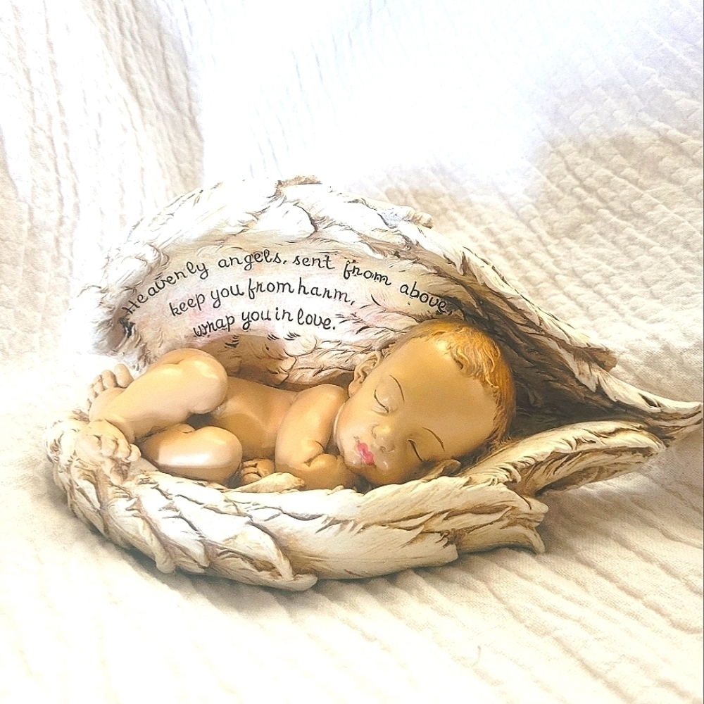 Sleeping baby in angel wings figurine, religious sculpture, prayer decor
